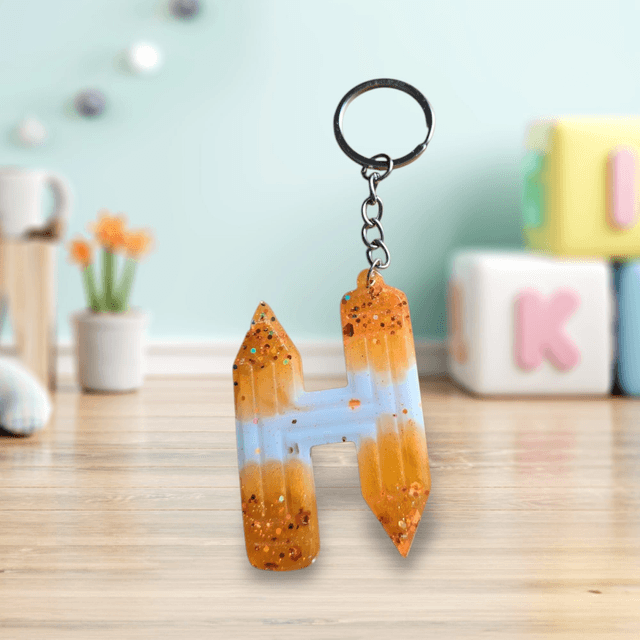 Porte-clés initiale crayons